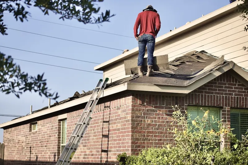 Professional roofer working on a residential roof in Westridge
